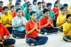 Kolkata young people meditating padmasana namaste eyes closed