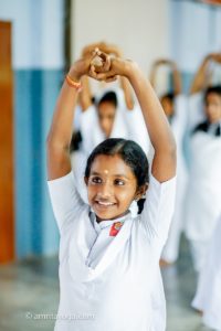 girl in white with raised arms