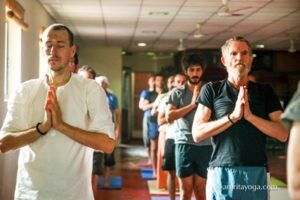 amrita yoga standing pose with prayer hands