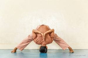 young person doing forward bend pose